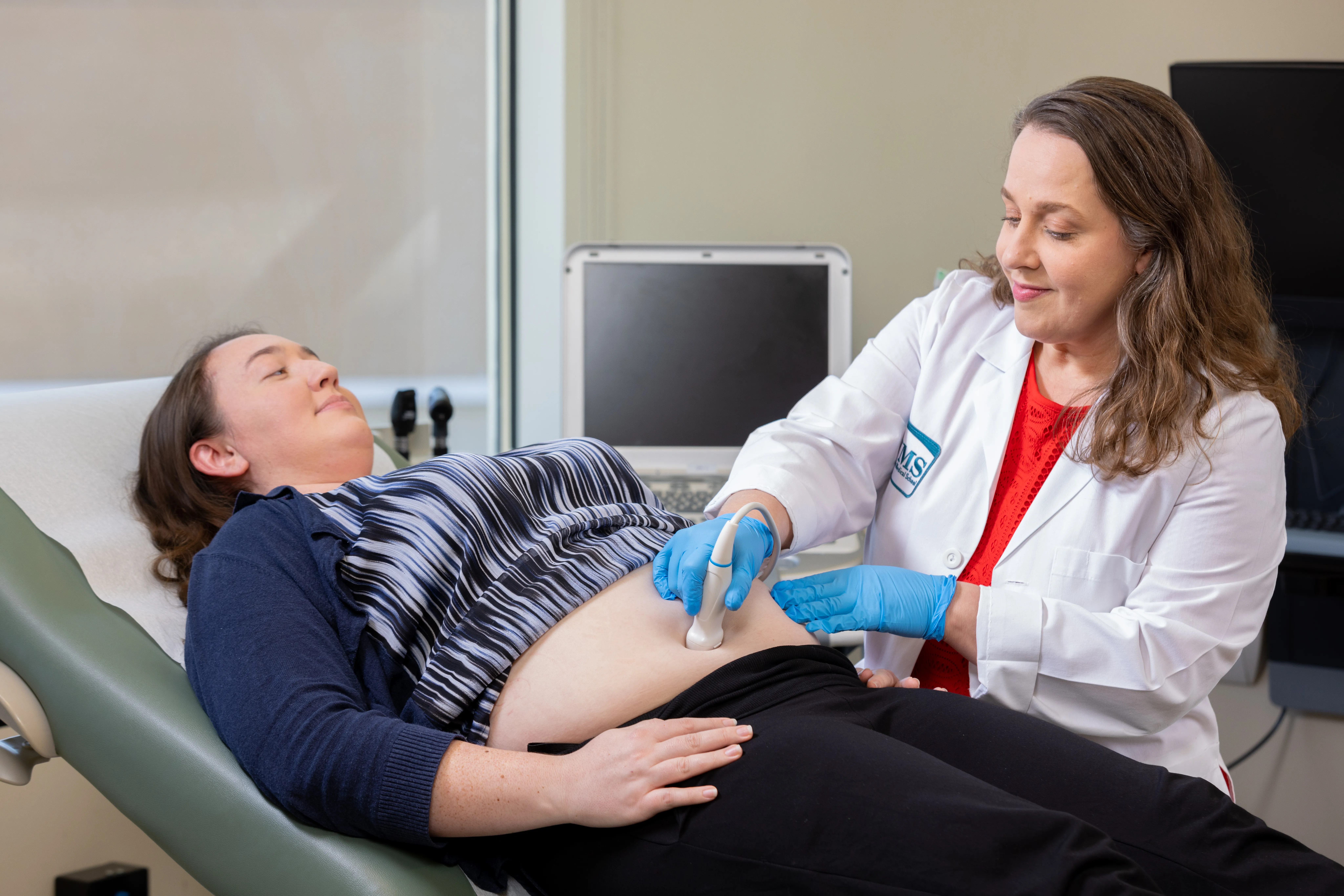 Dr. Morales comforting a patient with a pat on the arm.