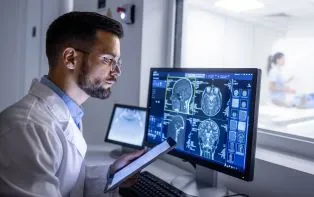 Technician reading a scan on a computer screen