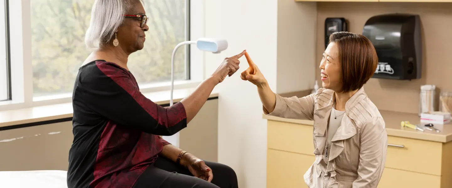 Dr. Kwon testing the motor skills of a patient by touching i