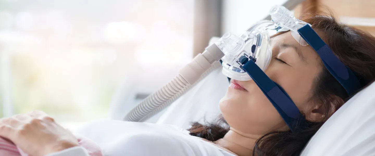 Senior woman using cpap machine to stop choking and snoring 