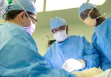 Dr. Britt and colleagues in surgery on an acute surgery case