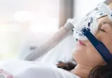 Senior woman using cpap machine to stop choking and snoring 