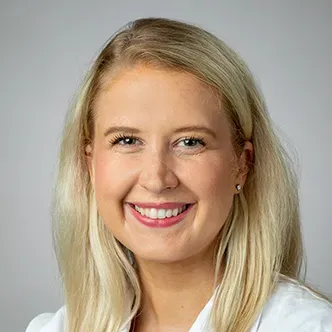 Dr. Wikner Bresnahan has long blonde hair, is wearing a whit