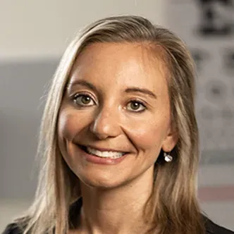 NP Harris has long blonde hair, is wearing black medical scr