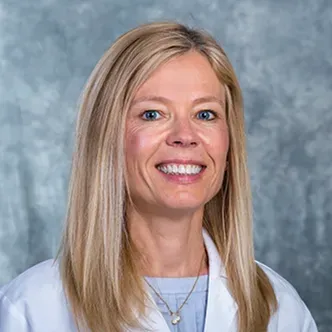 Dr. Margaret Baumgarten is a woman with long blonde hair, we